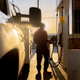 A photo of someone filling up a truck at a gas station in the USA.
